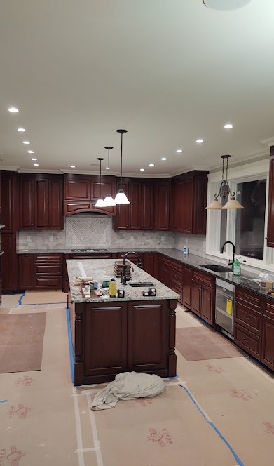 Luxury kitchen with cherry cabinets and warm pendant lighting